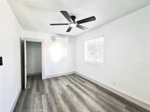a view of room with window and ceiling fan