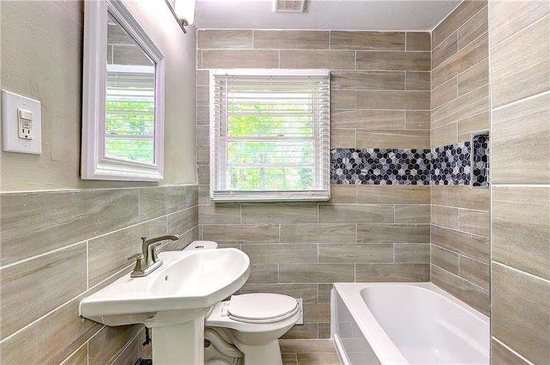 4973 White Boulevard Southwest Mableton, GA 30126 - Photo 18 of 22 a bathroom with a sink a toilet and shower