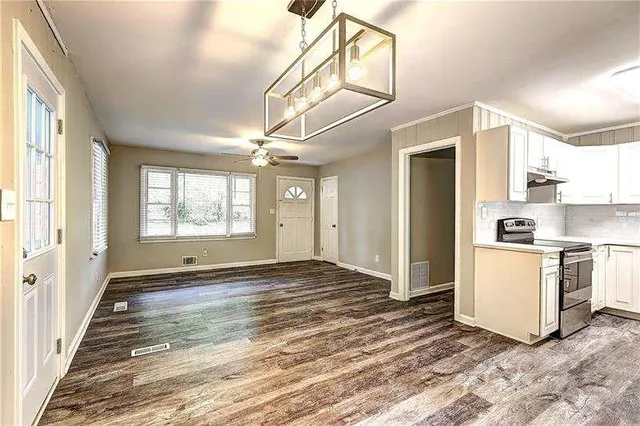 a view of a kitchen with stove and refrigerator