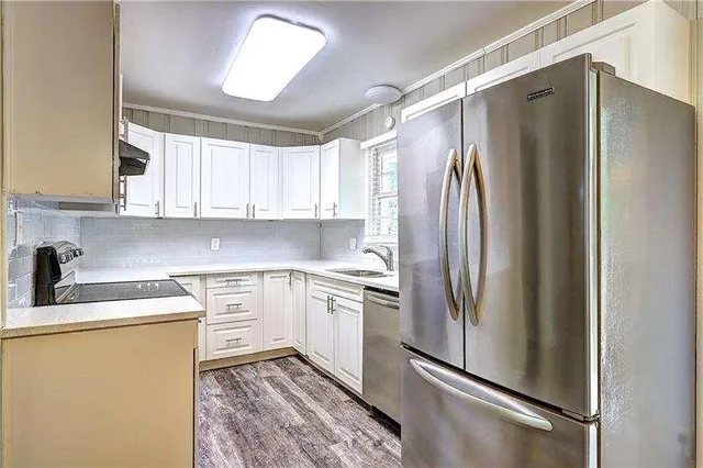a kitchen with stainless steel appliances granite countertop a refrigerator sink and cabinets
