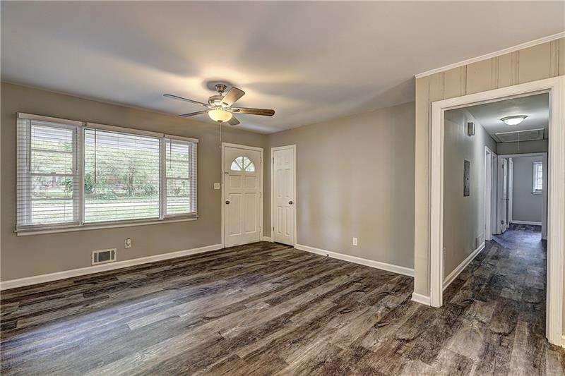 4973 White Boulevard Southwest Mableton, GA 30126 - Photo 7 of 22 wooden floor in an empty room with a window