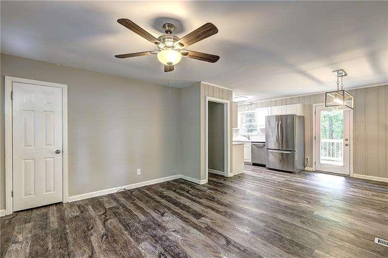 4973 White Boulevard Southwest Mableton, GA 30126 - Photo 8 of 22 a view of a livingroom with wooden floor and a ceiling fan
