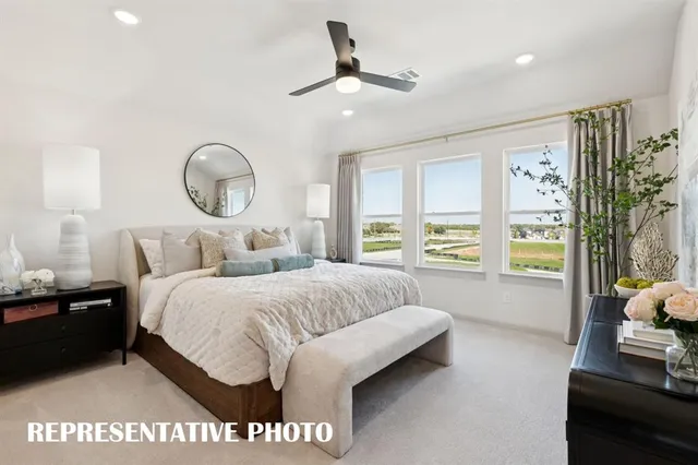 a kitchen with kitchen island granite countertop a stove a sink a microwave a refrigerator and white cabinets