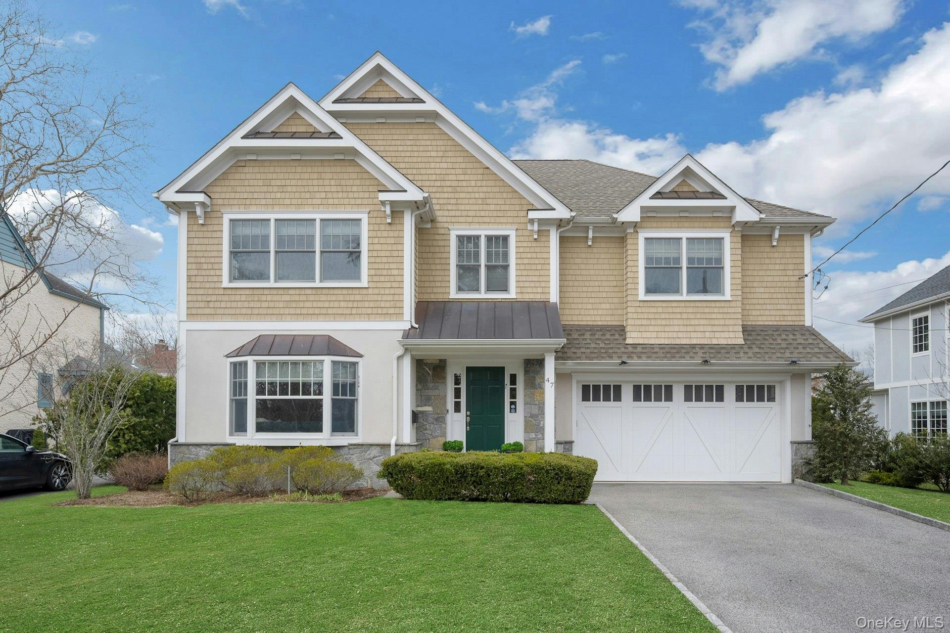 Beautiful 2016 Colonial showcasing timeless architecture, elegant symmetry, and impeccable curb appeal on a tranquil street in Scarsdale’s coveted Heathcote neighborhood.