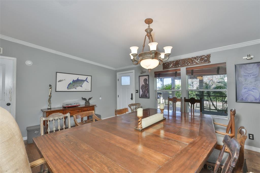 20112 Hobbs Road Wimauma, FL 33598 - Photo 11 of 94 a living room with dining table a large window and stainless steel appliances