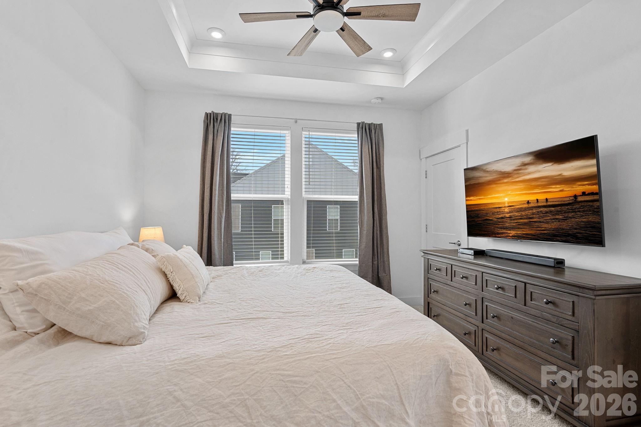 4012 Capital Ridge Charlotte, NC 28205 - Photo 15 of 28 a bedroom with a flat screen tv and a chandelier