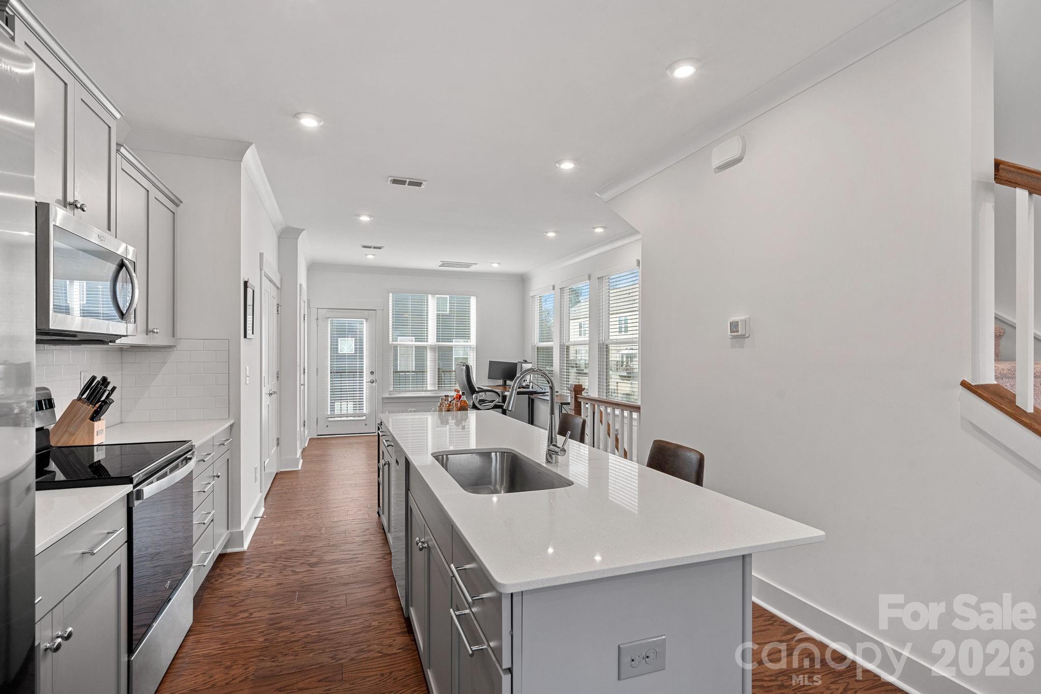 4012 Capital Ridge Charlotte, NC 28205 - Photo 9 of 28 a open kitchen with stainless steel appliances granite countertop a sink a stove and a refrigerator
