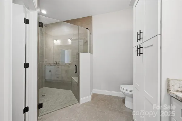 a bathroom with a shower and a toilet