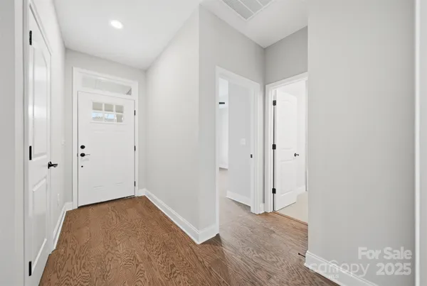 a view of hallway with wooden floor