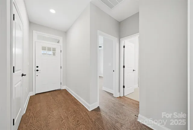 a view of hallway with wooden floor