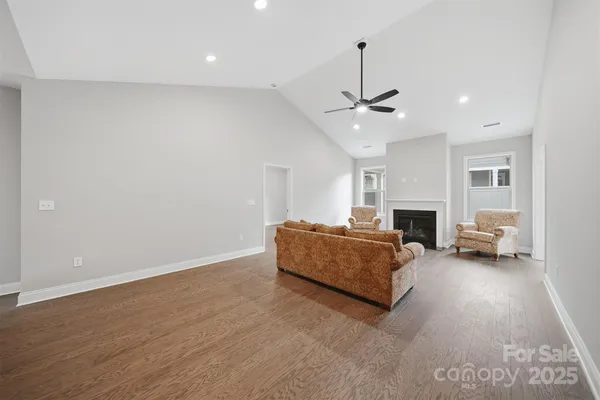 a living room with furniture a fireplace and a chandelier