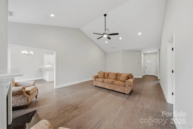 a living room with furniture and a ceiling fan