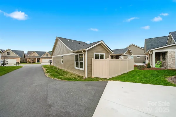 a view of a big house with a yard and plants