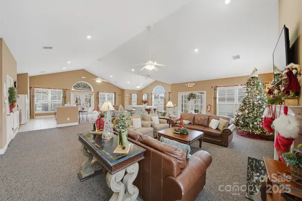 a living room with lots of furniture and a large window
