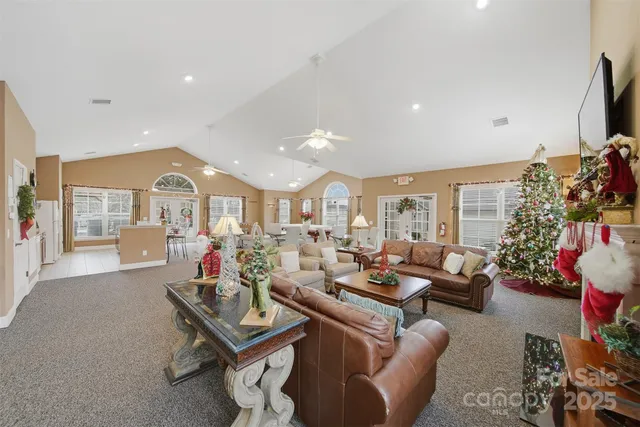 a living room with lots of furniture and a large window