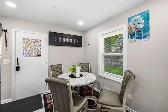 a view of a dining room with furniture window and outside view