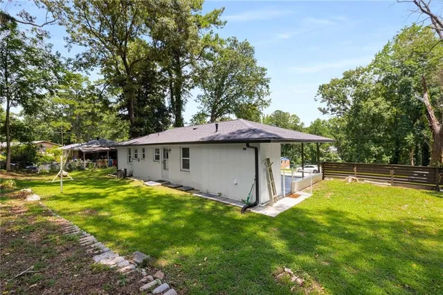 a view of a house with yard and sitting area