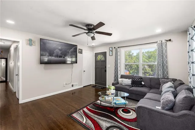 a living room with furniture and a flat screen tv