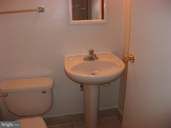 17670 Kohlhoss Road Poolesville, MD 20837 - Photo 2 of 12 a bathroom with a toilet sink and mirror