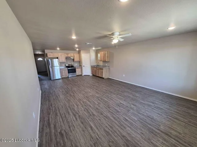 a view of a livingroom with hardwood floor and a ceiling fan