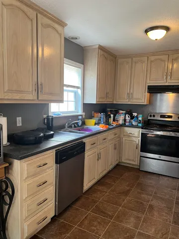 a kitchen with appliances cabinets and a sink