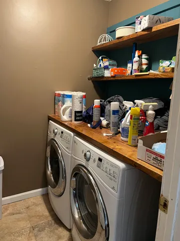 a utility room with lots of clutter and washer