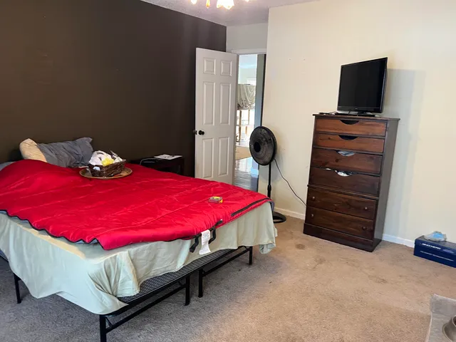 a living room with furniture and a mirror