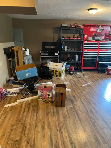 a view of a livingroom with furniture a ceiling fan and wooden floor