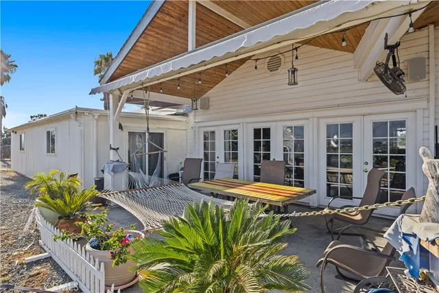 a view of a patio with a table and chairs