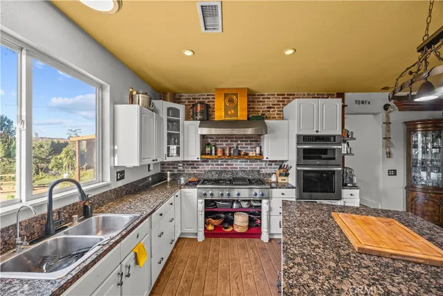 a living room with furniture a flat screen tv and a table