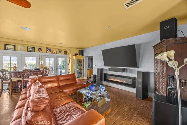 a utility room with stainless steel appliances kitchen island granite countertop a sink and a refrigerator