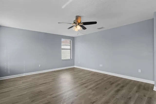 a bathroom with a granite countertop sink a toilet and bathtub