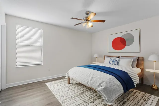 a bedroom with a large bed and a window