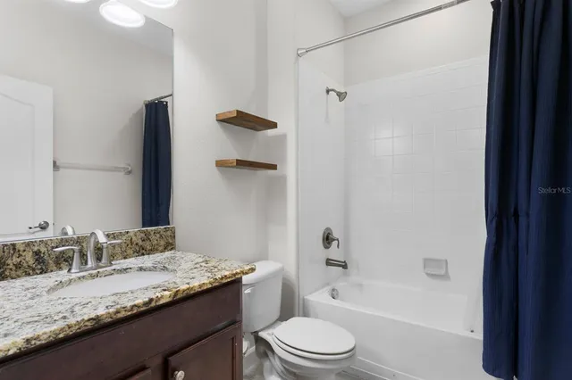 an aerial view of residential houses with outdoor space and river