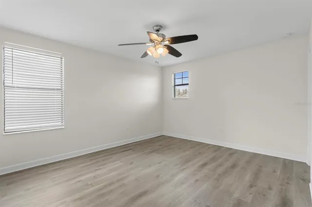 an aerial view of a swimming pool with outdoor seating and yard