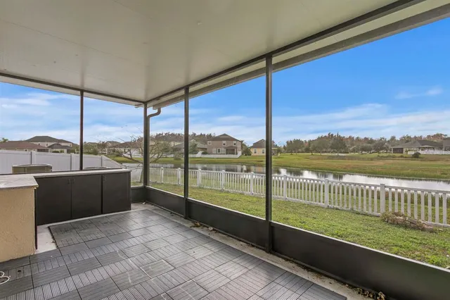 an aerial view of residential houses with outdoor space and river