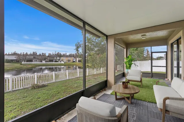 an aerial view of residential houses with outdoor space and lake view