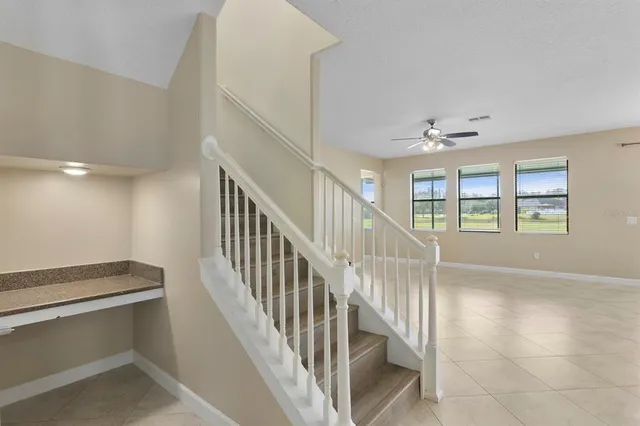 a view of a kitchen with a sink and stainless steel appliances