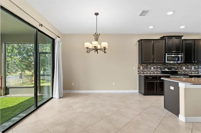 a kitchen with stainless steel appliances granite countertop a refrigerator a stove a sink and a oven