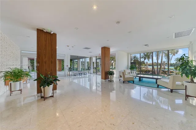 a living room with furniture and potted plants