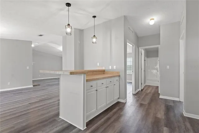 a kitchen with granite countertop white cabinets and white appliances