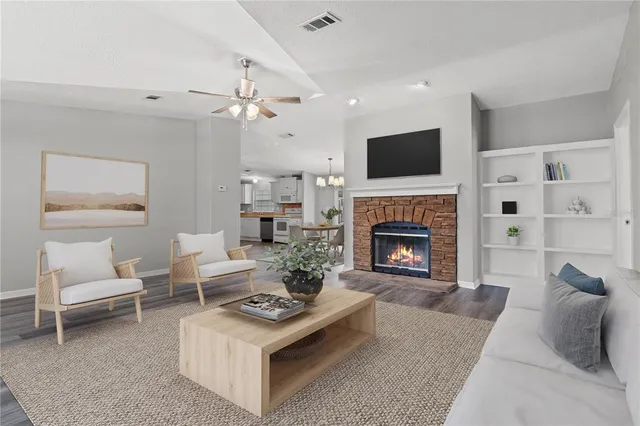 a backyard of a house with plants and large tree