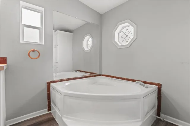 a view of a house with backyard and a tree