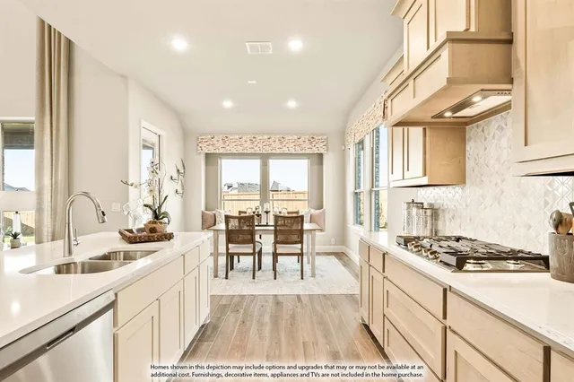 a kitchen with counter top space a sink cabinets and appliances