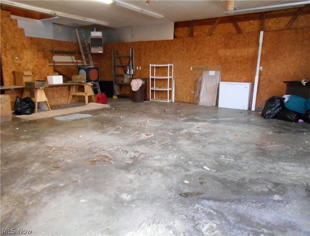 4370 School House Road Little Hocking, OH 45742 - Photo 33 of 35 Garage offers electric, a gas heater & a wood stove, and 2nd floor storage