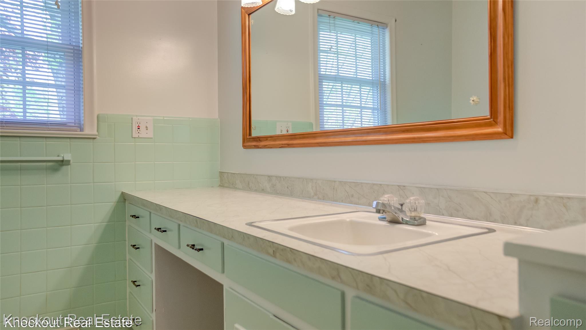 4465 Dirker Road Saginaw, MI 48638 - Photo 33 of 56 Bathroom with vanity and tile walls