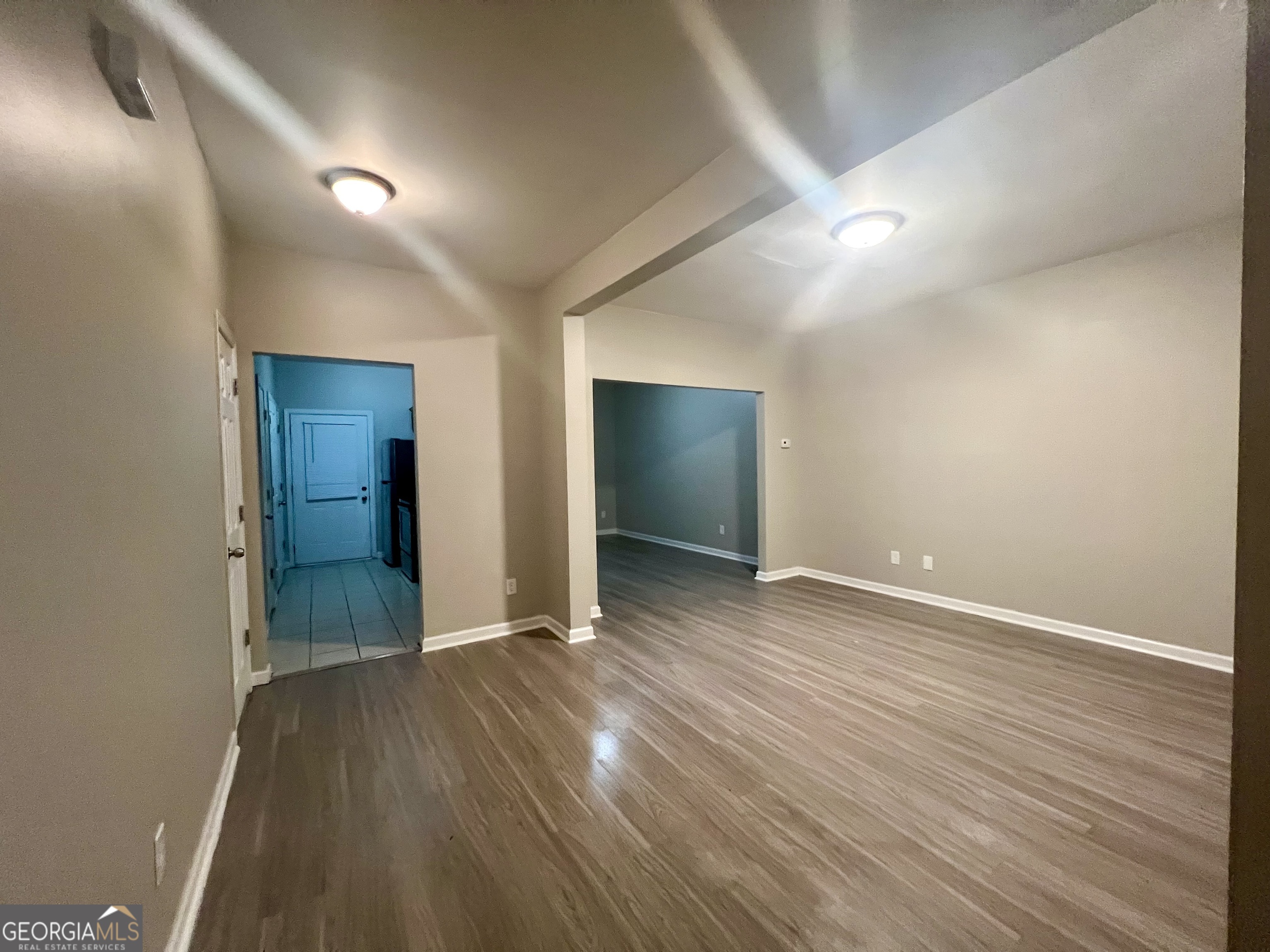 1005 Mill Creek Way, Unit B Monroe, GA 30655 - Photo 2 of 11 wooden floor in an empty room with wooden floor