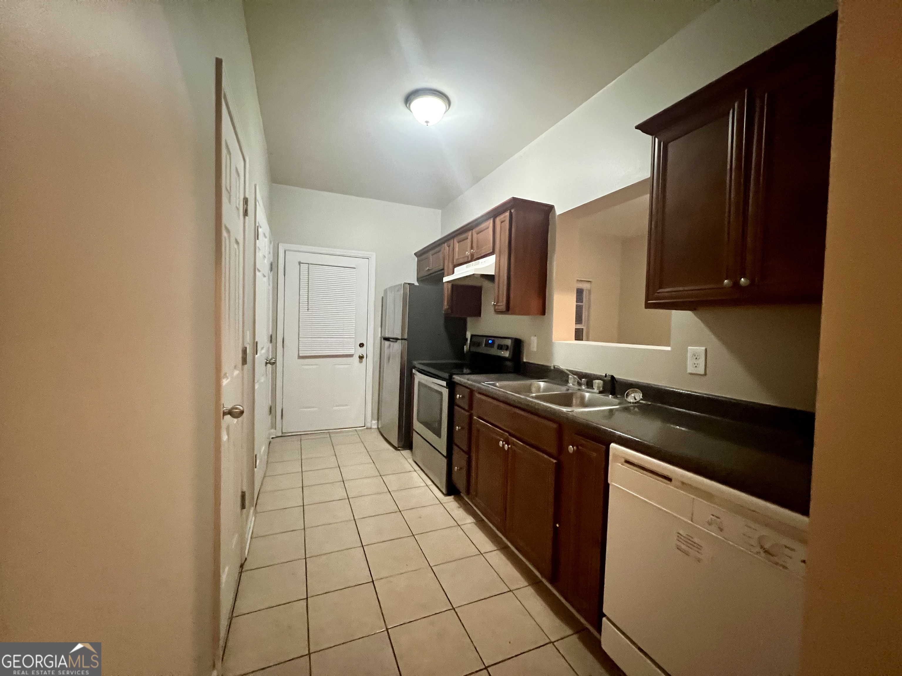 1005 Mill Creek Way, Unit B Monroe, GA 30655 - Photo 3 of 11 a kitchen with stainless steel appliances granite countertop a stove a sink and a refrigerator