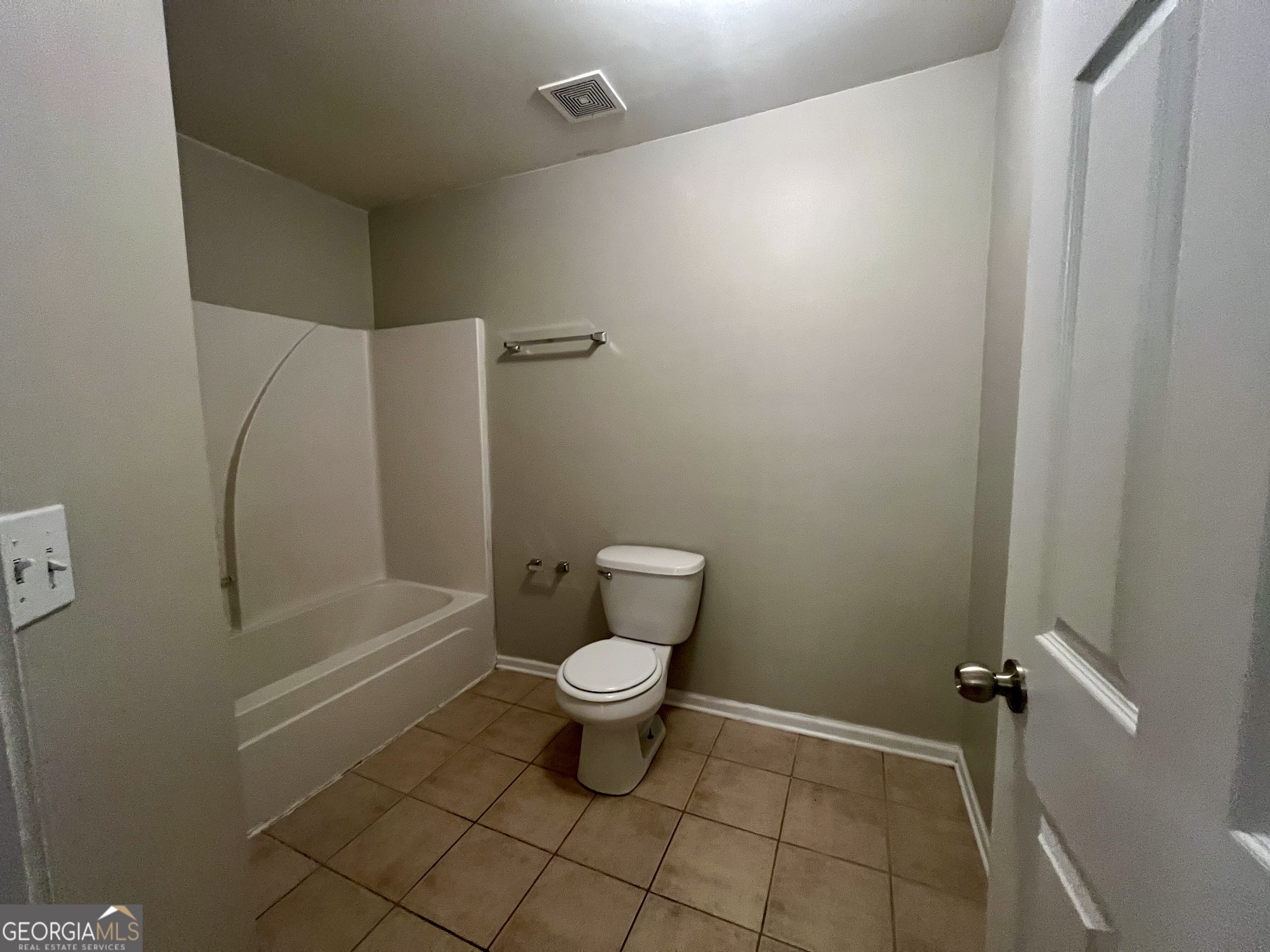 1005 Mill Creek Way, Unit B Monroe, GA 30655 - Photo 8 of 11 a bathroom with a toilet and a shower
