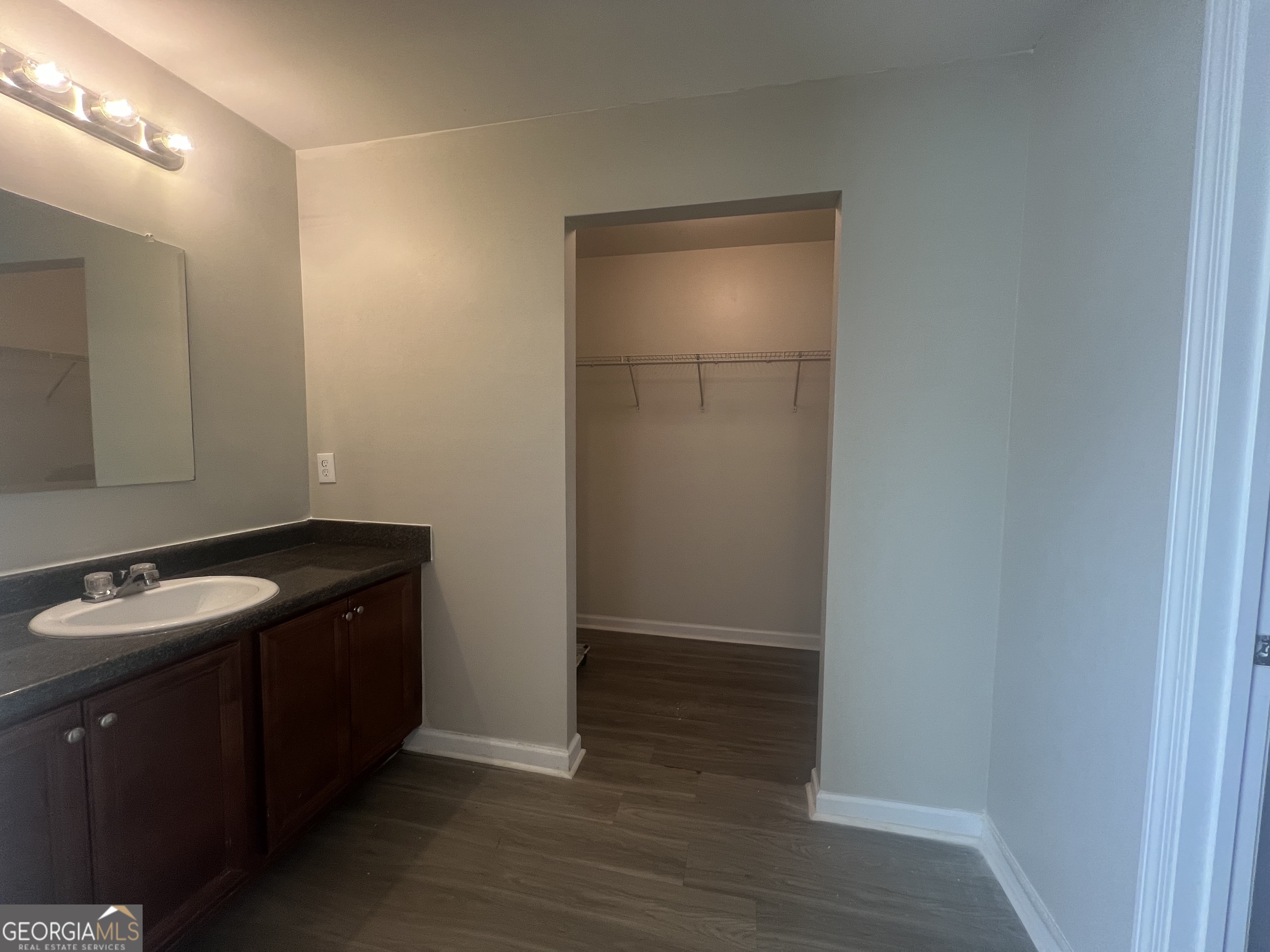 1005 Mill Creek Way, Unit B Monroe, GA 30655 - Photo 10 of 11 a bathroom with a sink and a mirror